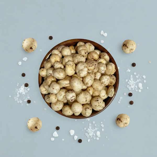 Premium photoshoot of Himalayan Salt & Black Pepper Makhana with seasoning accents