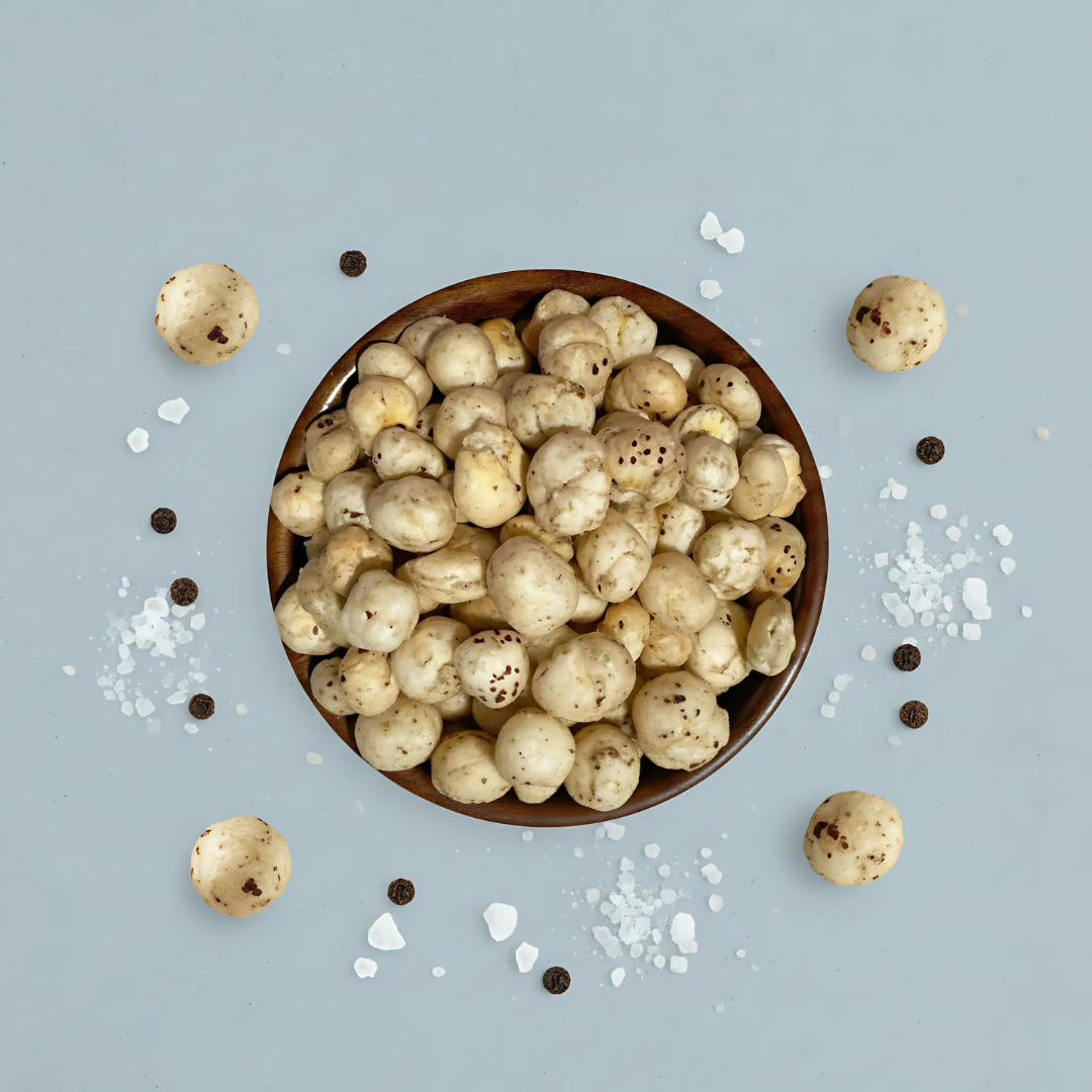 Premium photoshoot of Himalayan Salt & Black Pepper Makhana with seasoning accents