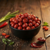 A bowl of gochujang flavoured makhana coated with a rich, spicy Korean-style seasoning, styled for a bold snack look