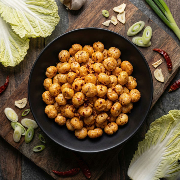 Top view of kimchi flavoured makhana in a bowl, highlighting its vibrant colour and seasoned surface