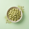 Top view of wasabi makhana arranged neatly on a light green background, showing its fresh wasabi coating