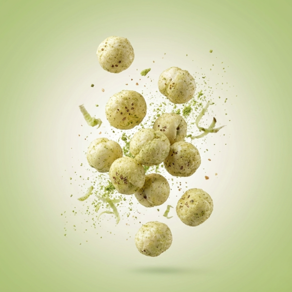 Floating wasabi makhana showing its crunchy texture and fresh green seasoning against a soft background