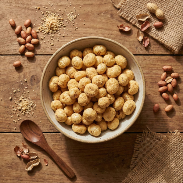 Top view of peanut butter flavoured makhana in a bowl, highlighting its golden colour and roasted texture