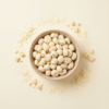 Top view of white cheddar makhana arranged neatly on a soft ivory background, showing its creamy cheese finish
