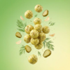 Floating dill pickle makhana showing its crisp texture and light green herb coating against a soft background